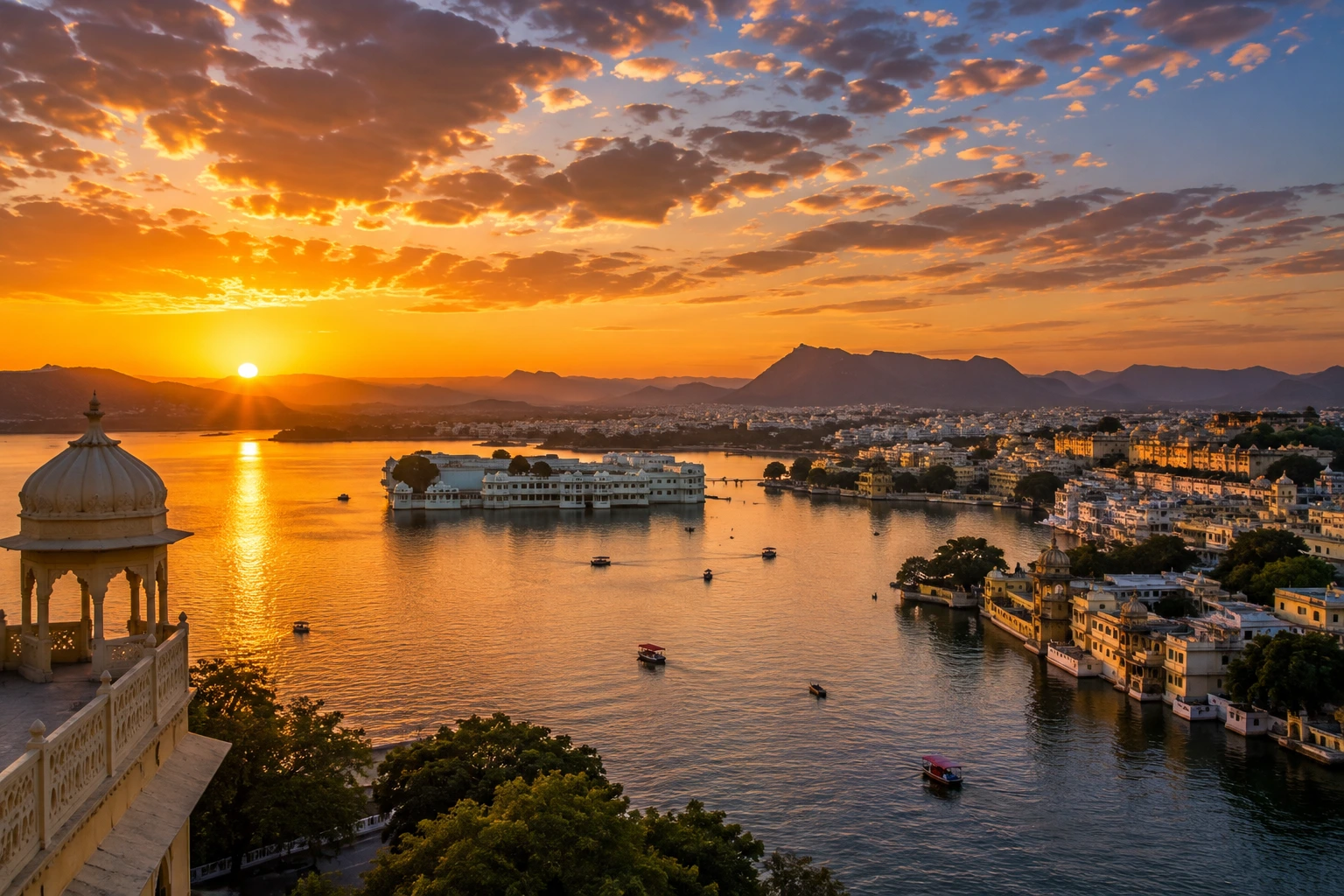 Sunset over Udaipur with Lake Pichola, city skyline and Aravalli hills